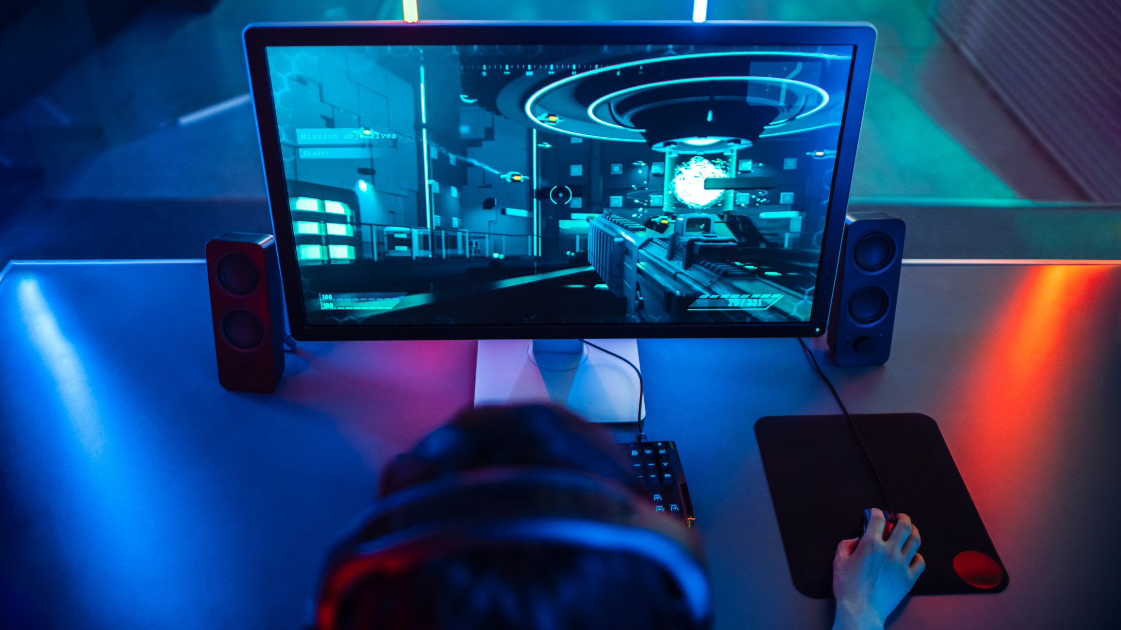 Person playing video games in dark room. 