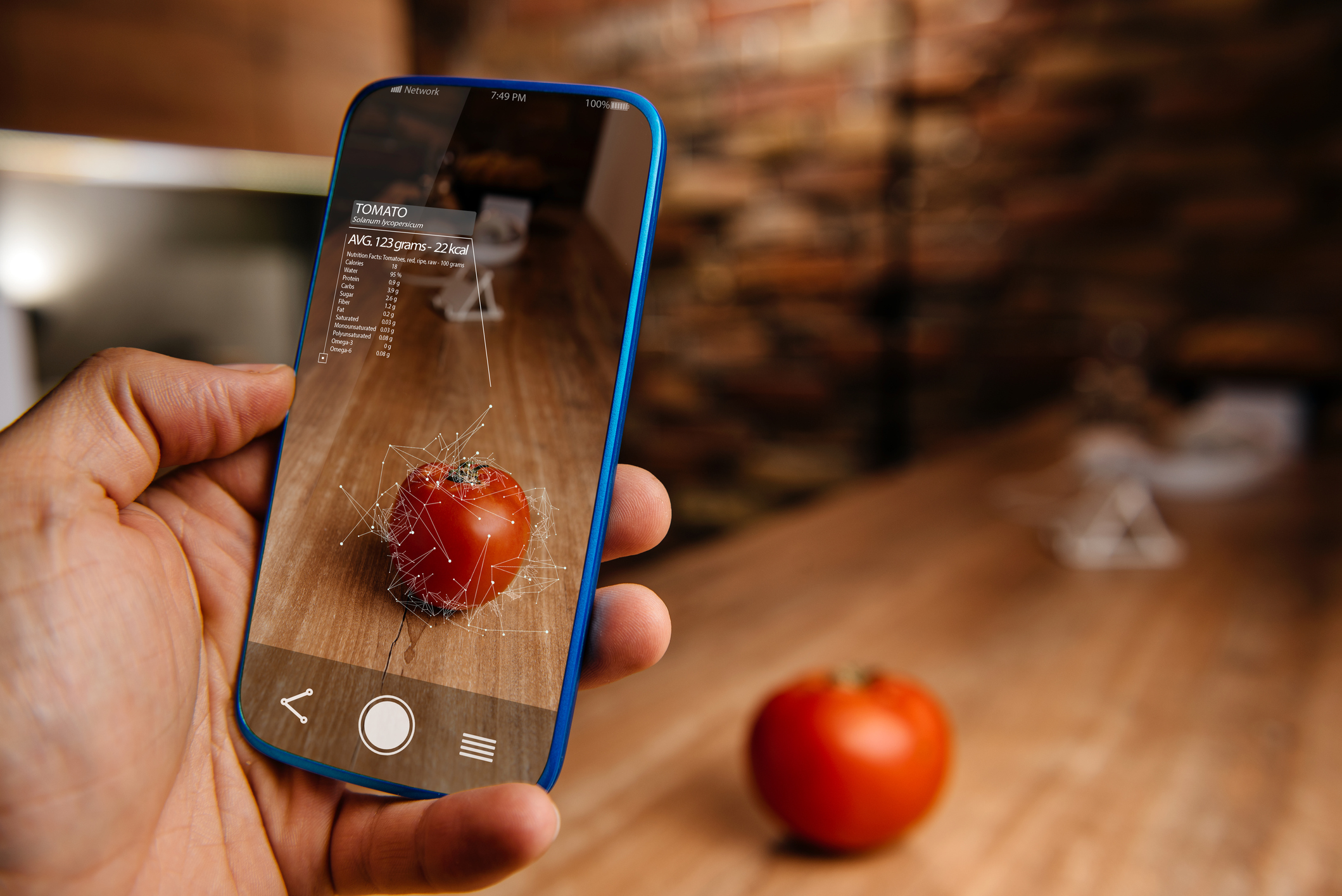 A man uses an AR smartphone app to scan an Apple.