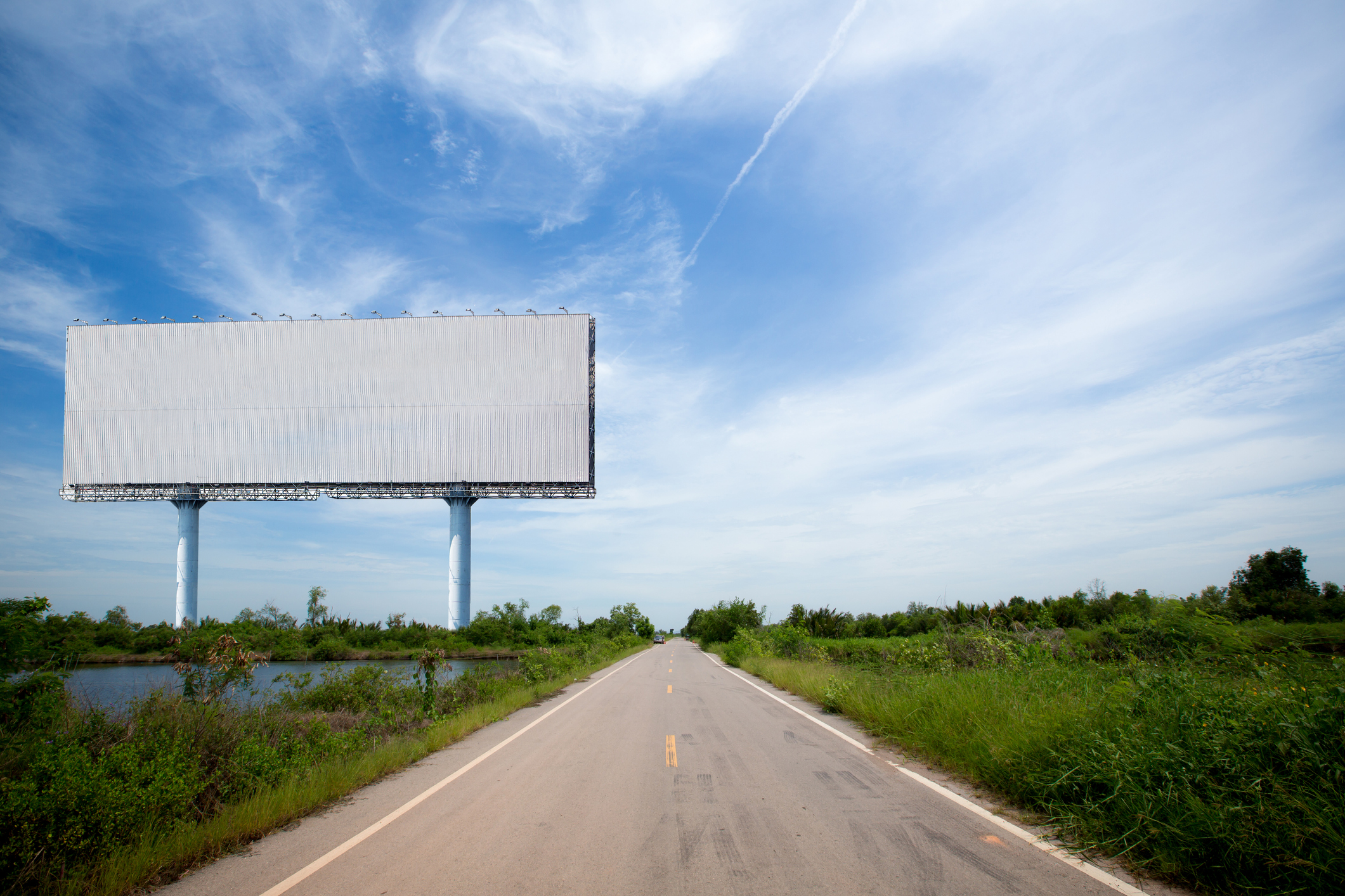 Blank billboard next to a country road