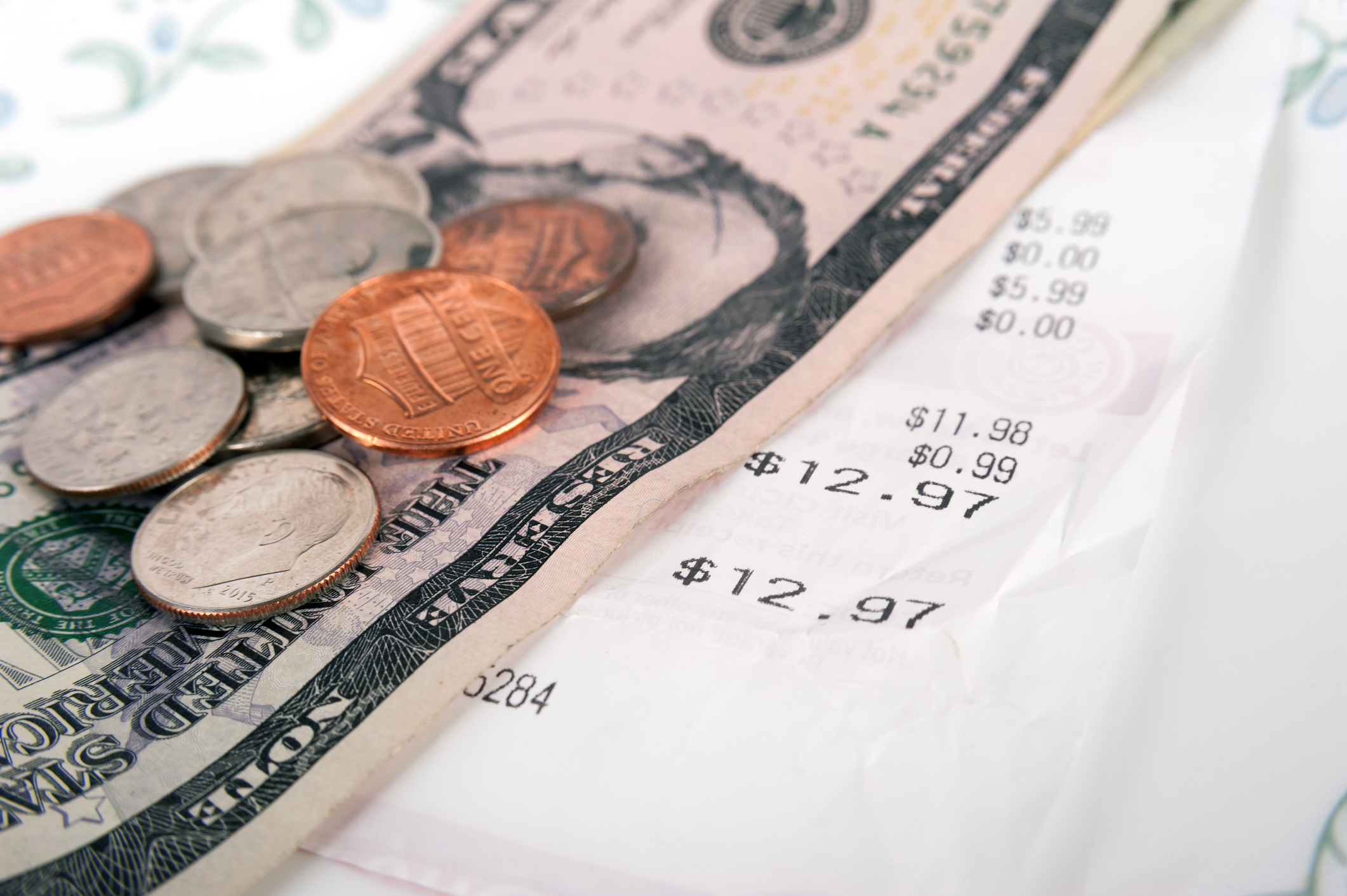 Restaurant receipt with dollar bill and change