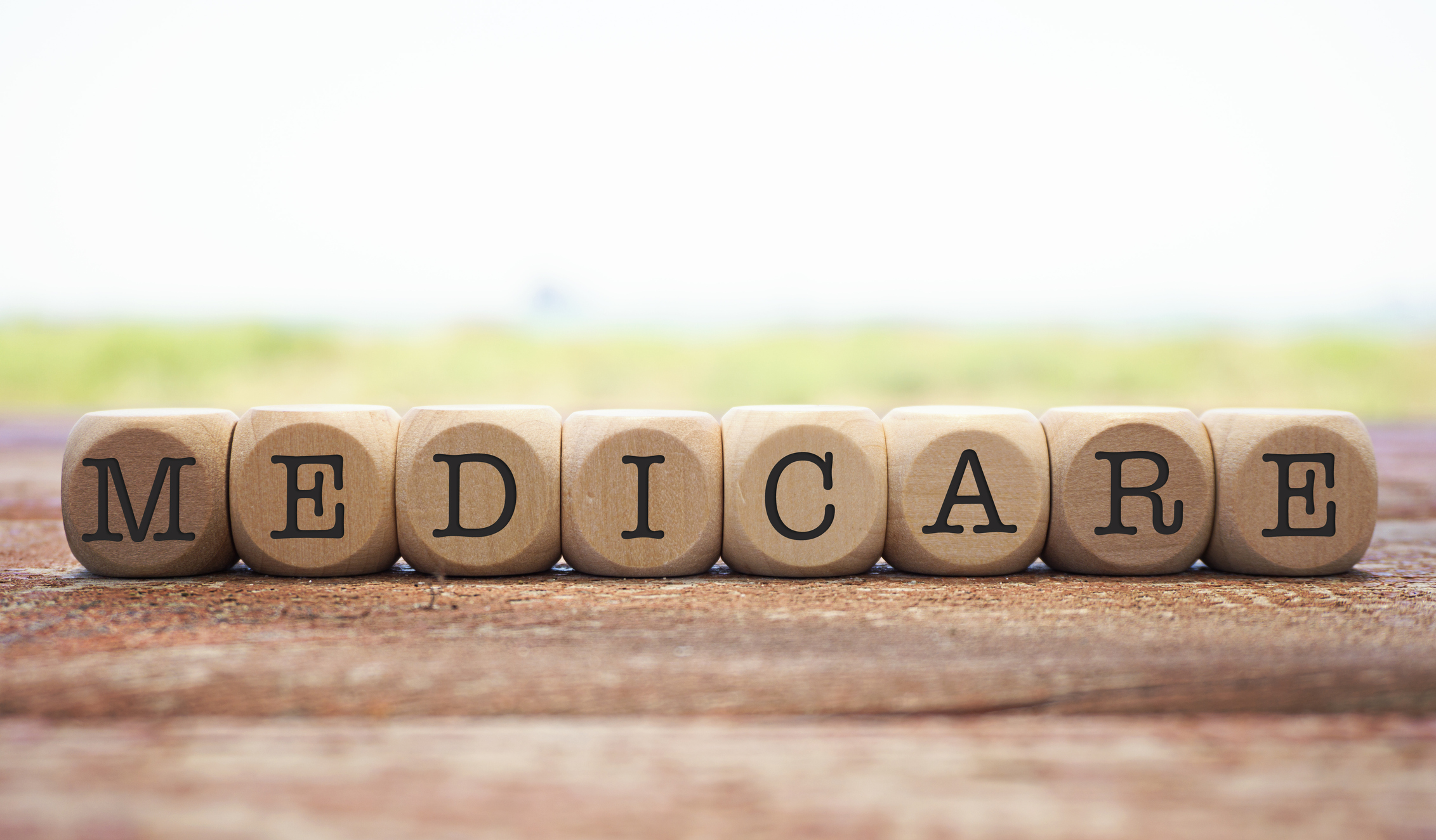 The word Medicare spelled out in round beads