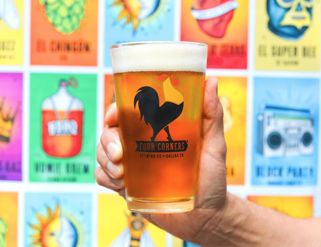 Hand holding glass of four corners beer