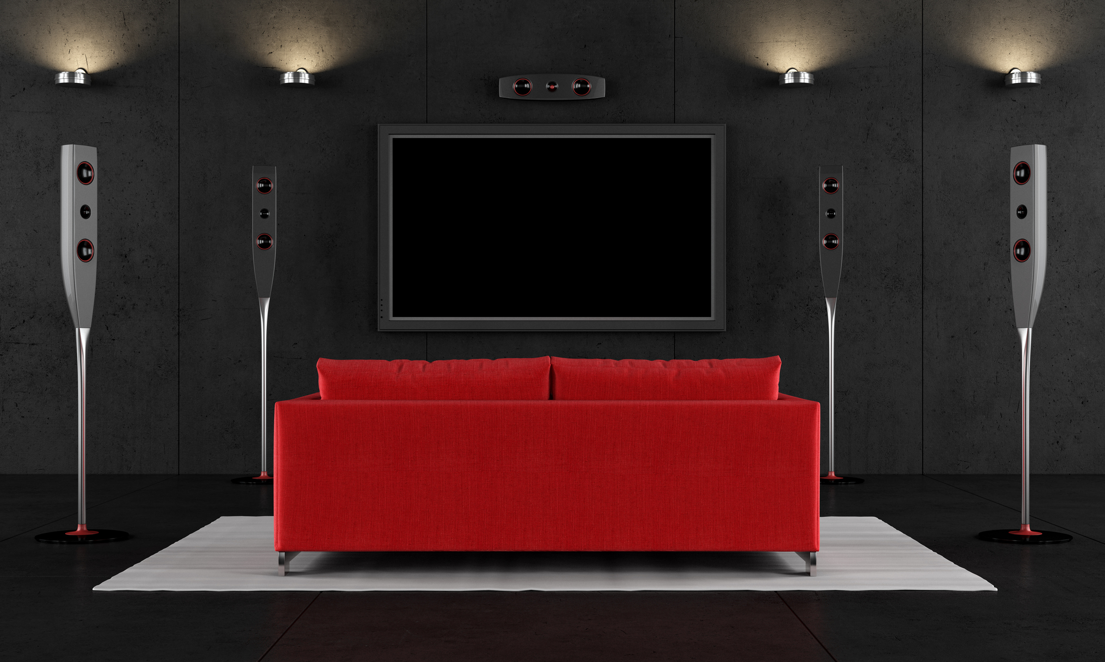 A red couch facing a TV in a home theater.