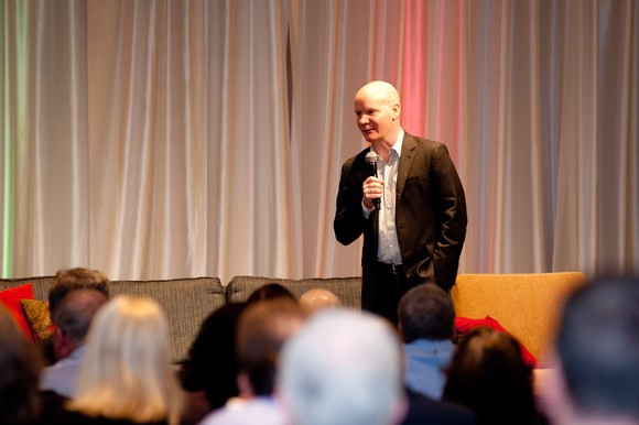 Motley Fool CEO Tom Gardner addresses a room of individual investors.