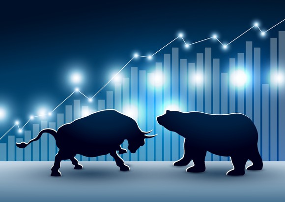 An image of a bear and bull doing battle.