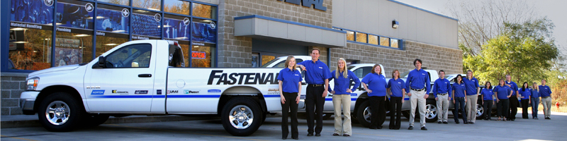Fastenal employees standing in front of a company truck and store location