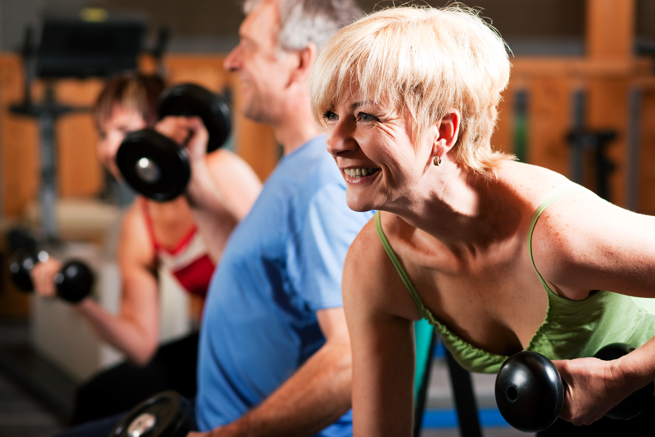 People lifting weights in a gym