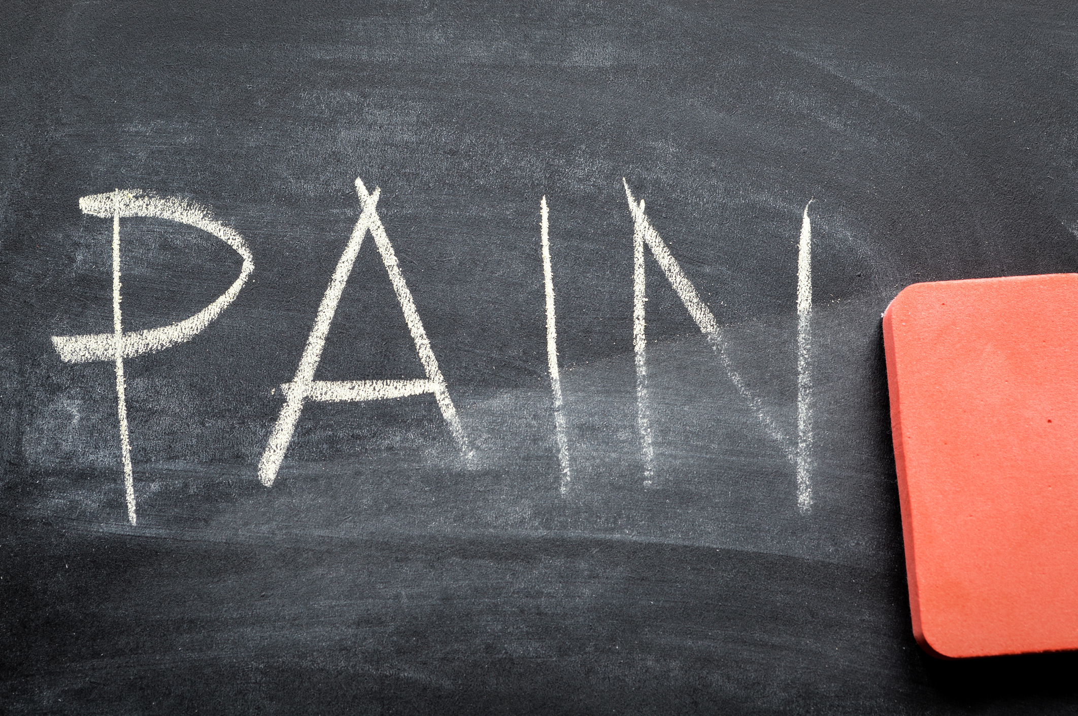 Chalkboard with the word "pain" written on it in capital letters.
