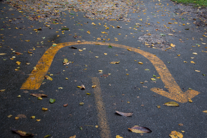 A turnaround sign drawn on pavement.