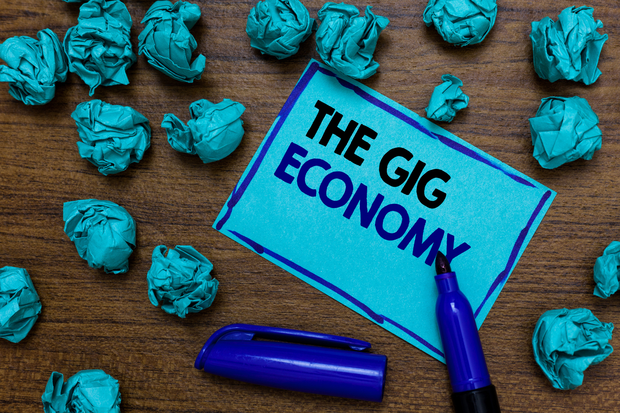 A marker on top of a note that says The Gig Economy.