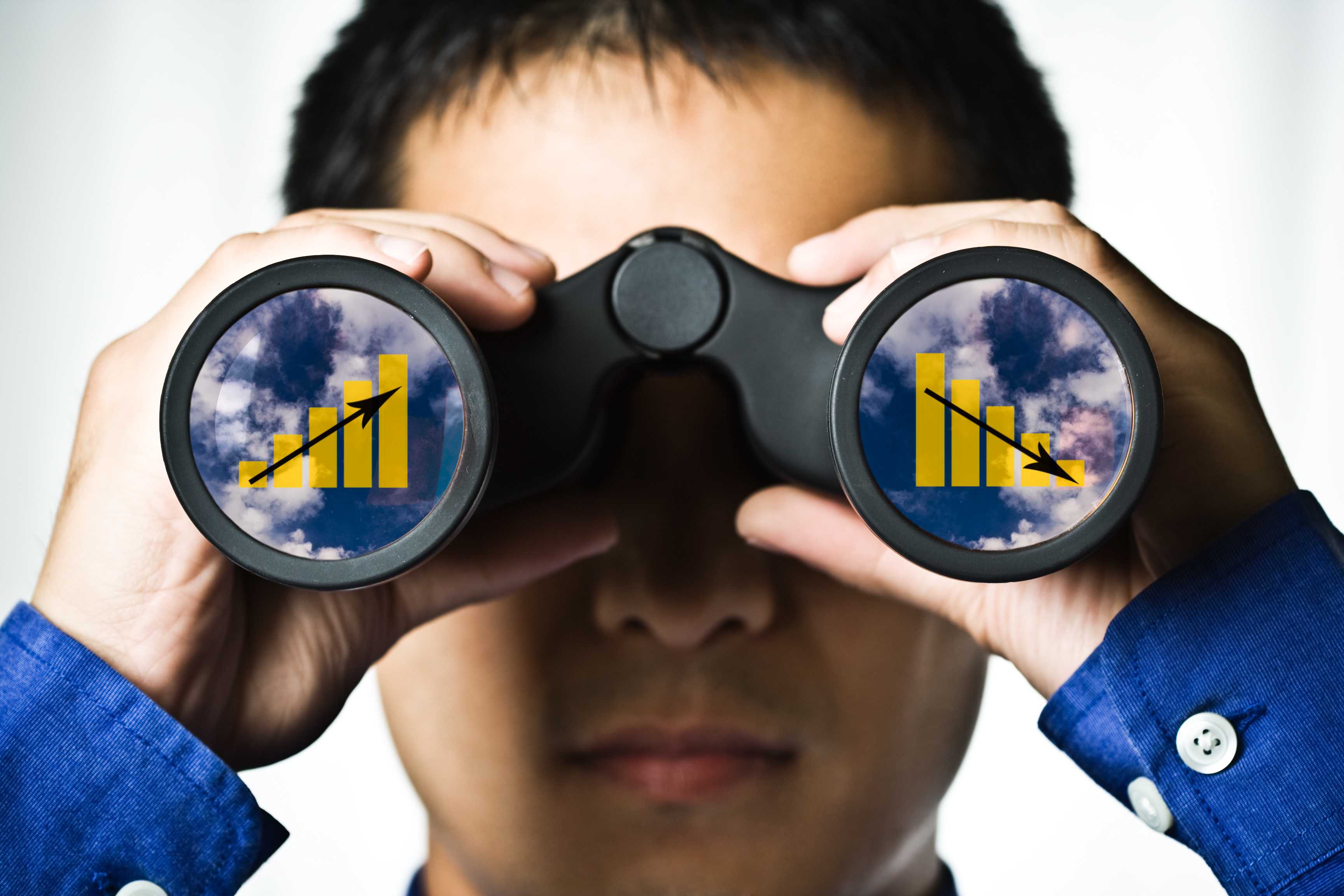 Man looking through binoculars with charts appearing in both lenses