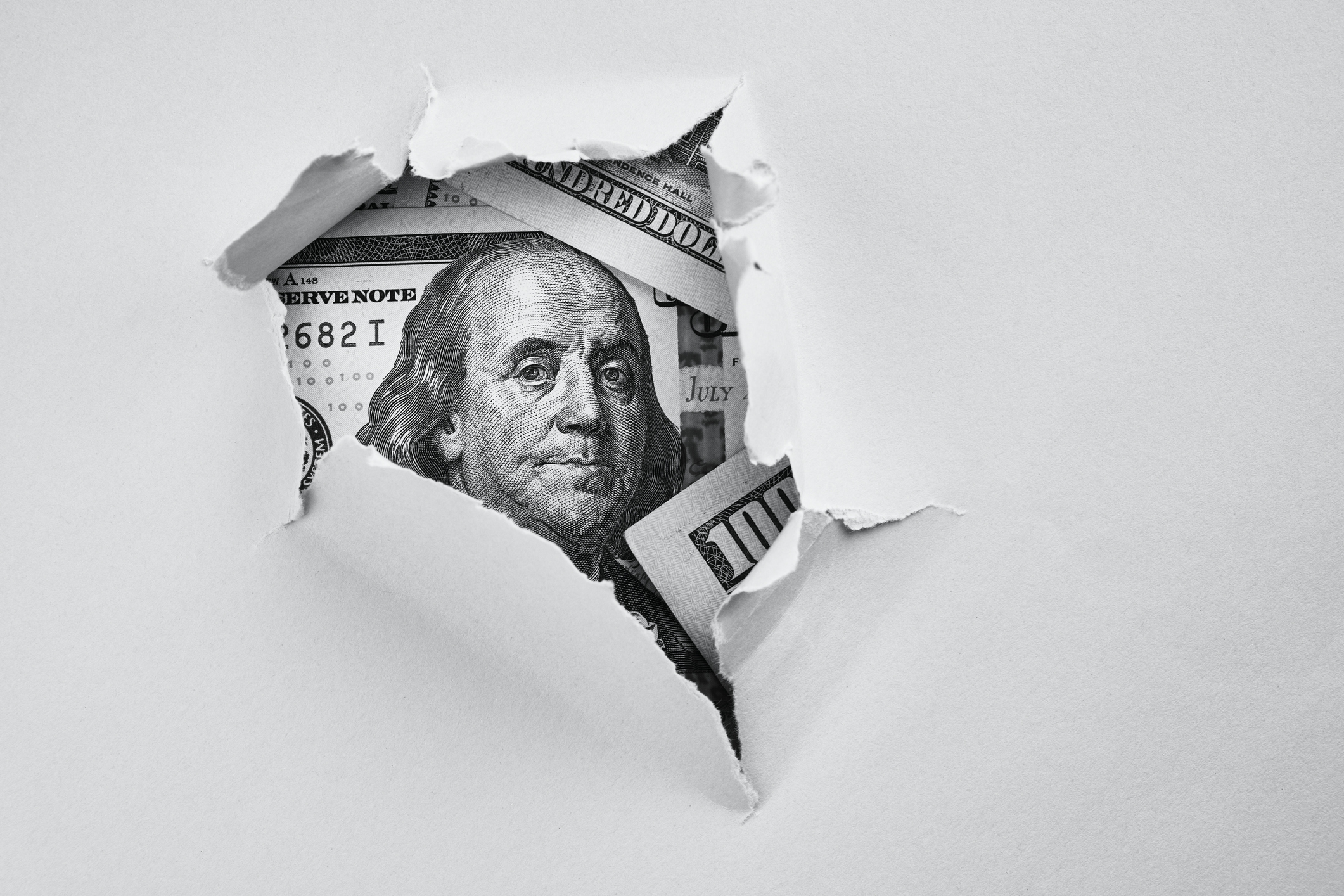 Dollar bill hidden behind a piece of paper