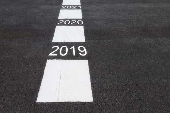 White rectangles and years 2019 through 2021 painted on a road surface.