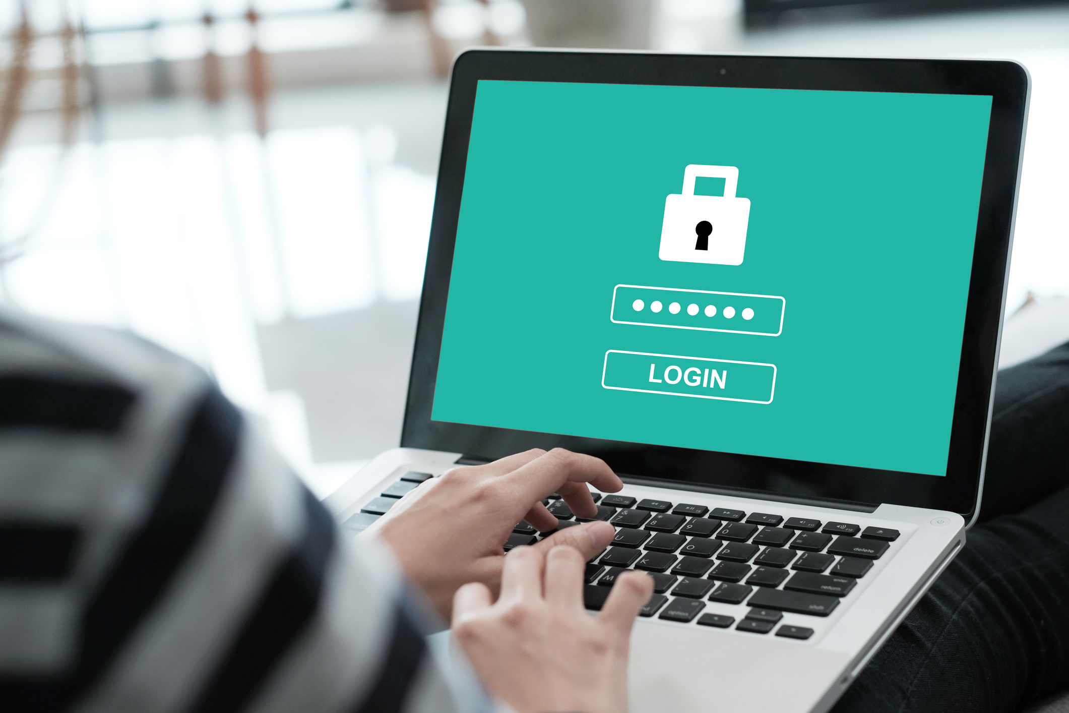 A person logging securely into an application on a laptop