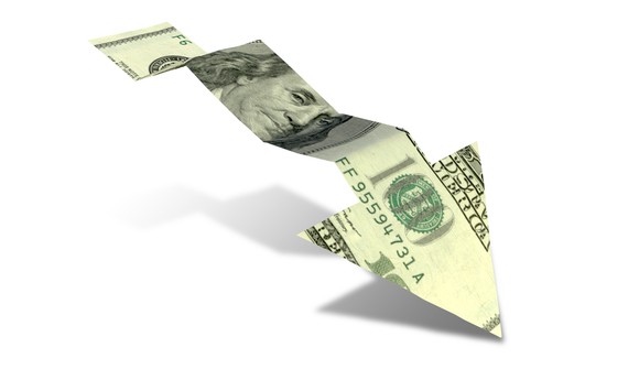 $100 bill cut to form an arrow that's pointing downward
