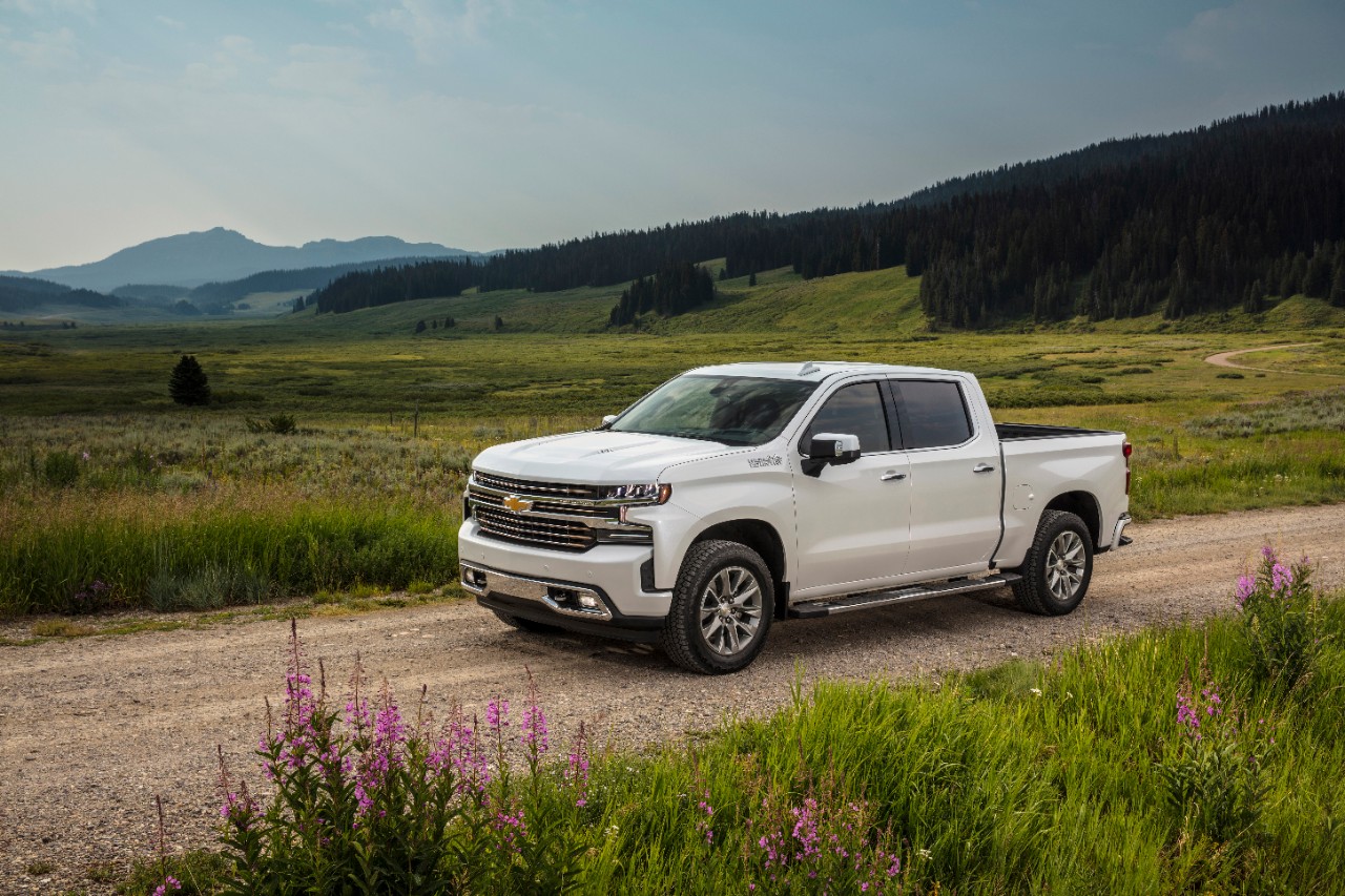 A white Chevy Silverado on a rural road.
