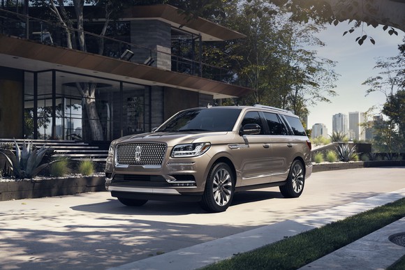 A Lincoln Navigator parked in front of a building