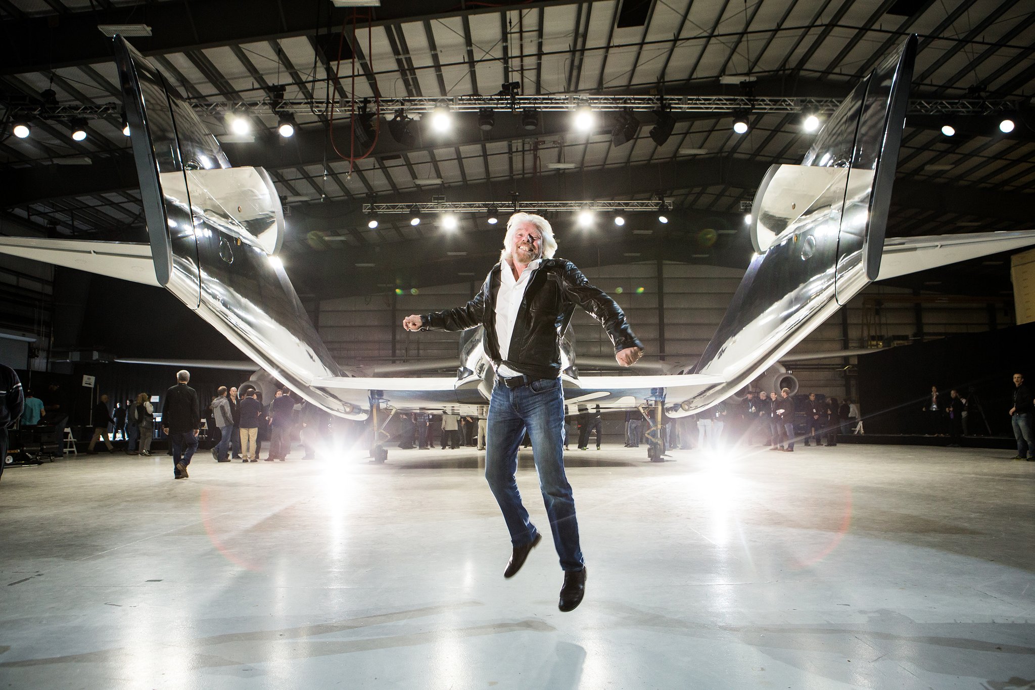 Sir Richard Branson leaping for joy in front of WhiteKnightTwo mothership IS Virgin Galactic