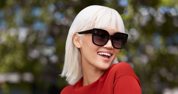 A woman wearing Snap's Spectacles.