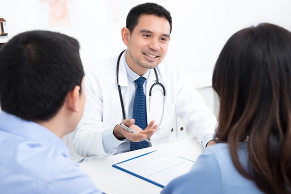 Doctor sitting across from couple