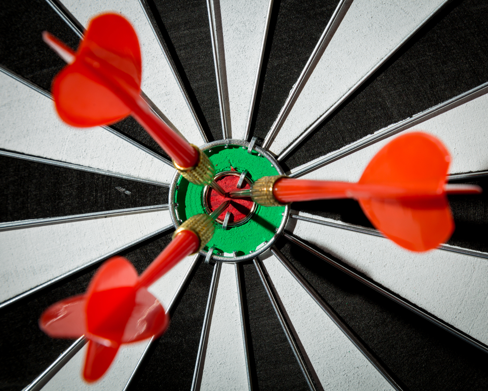 Three darts in the bullseye of a target board