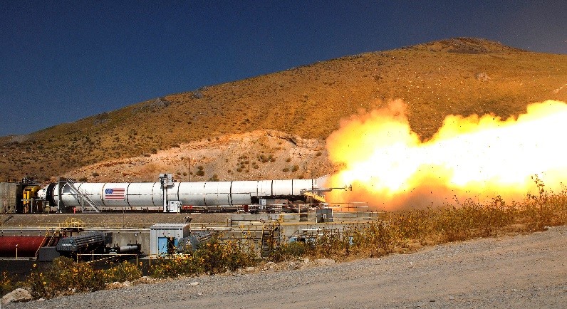 Flames shoot out of a solid rocket motor during a ground test.
