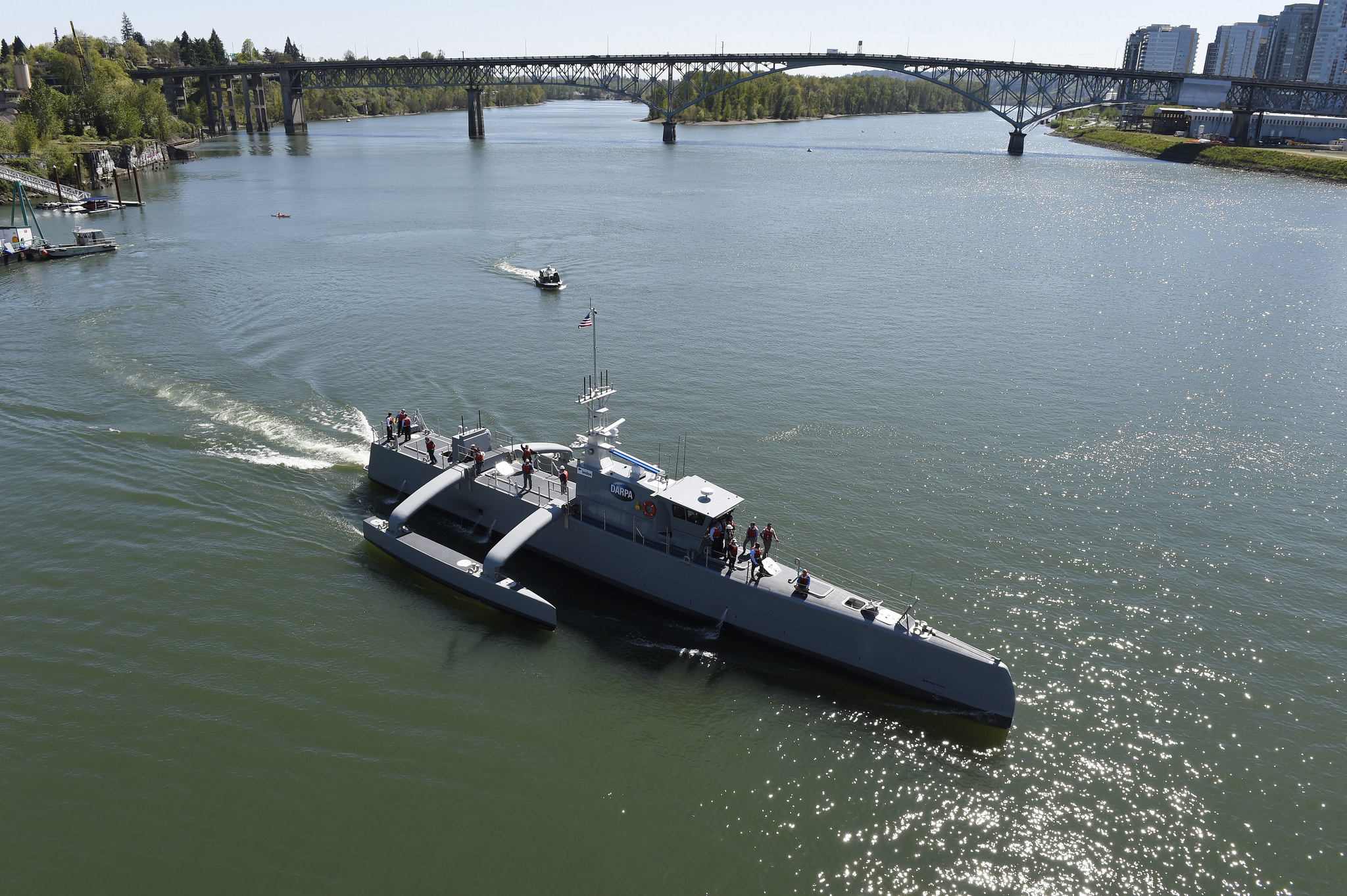 The Sea Hunter autonomous ship makes a turn in a river.