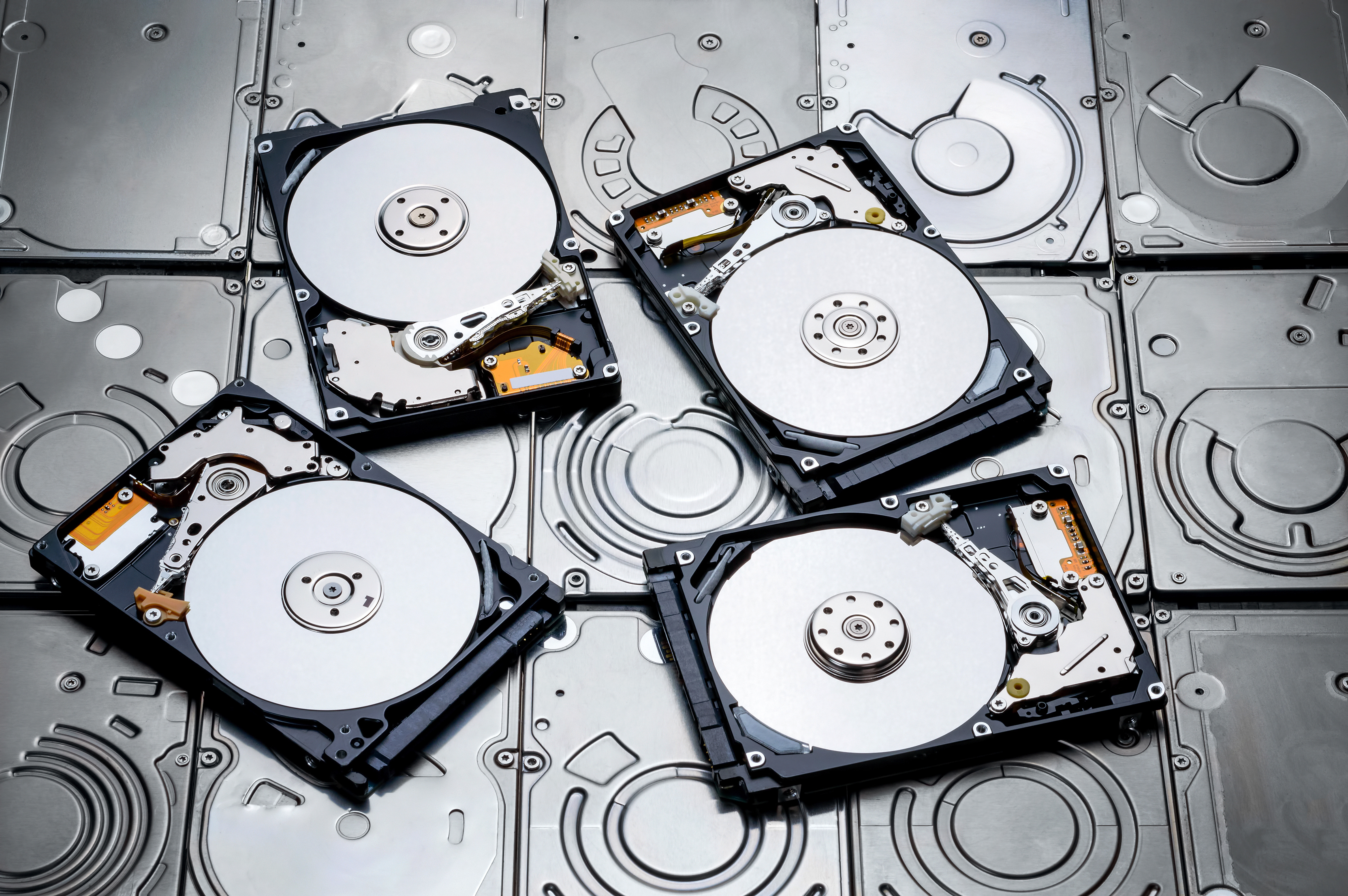 Four overturned HDDs placed atop other HDDs.