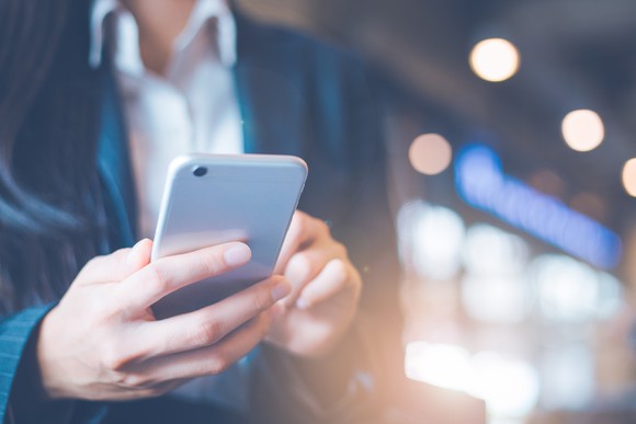 A woman holding a mobile phone.