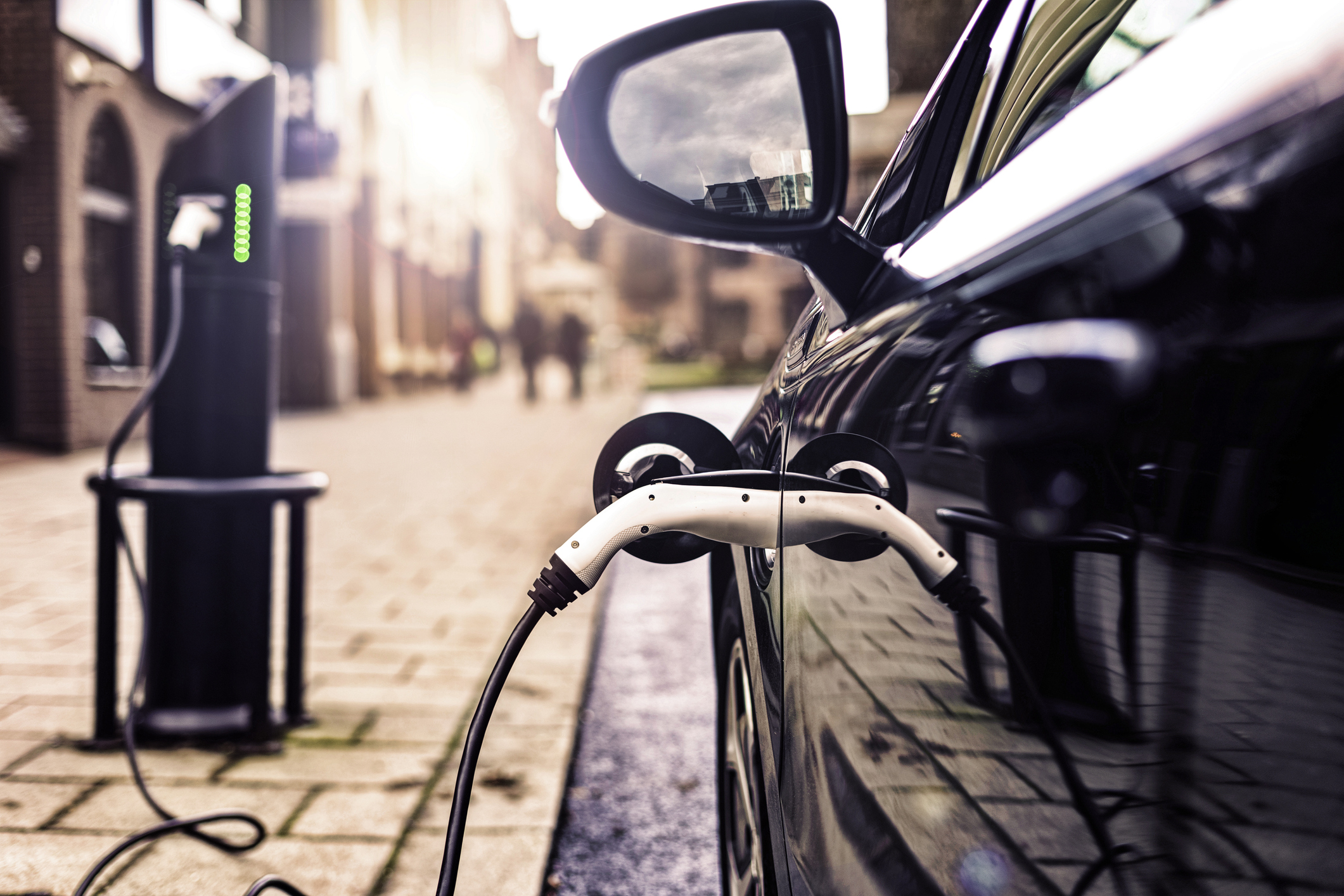 An electric car charges on a U.K. street