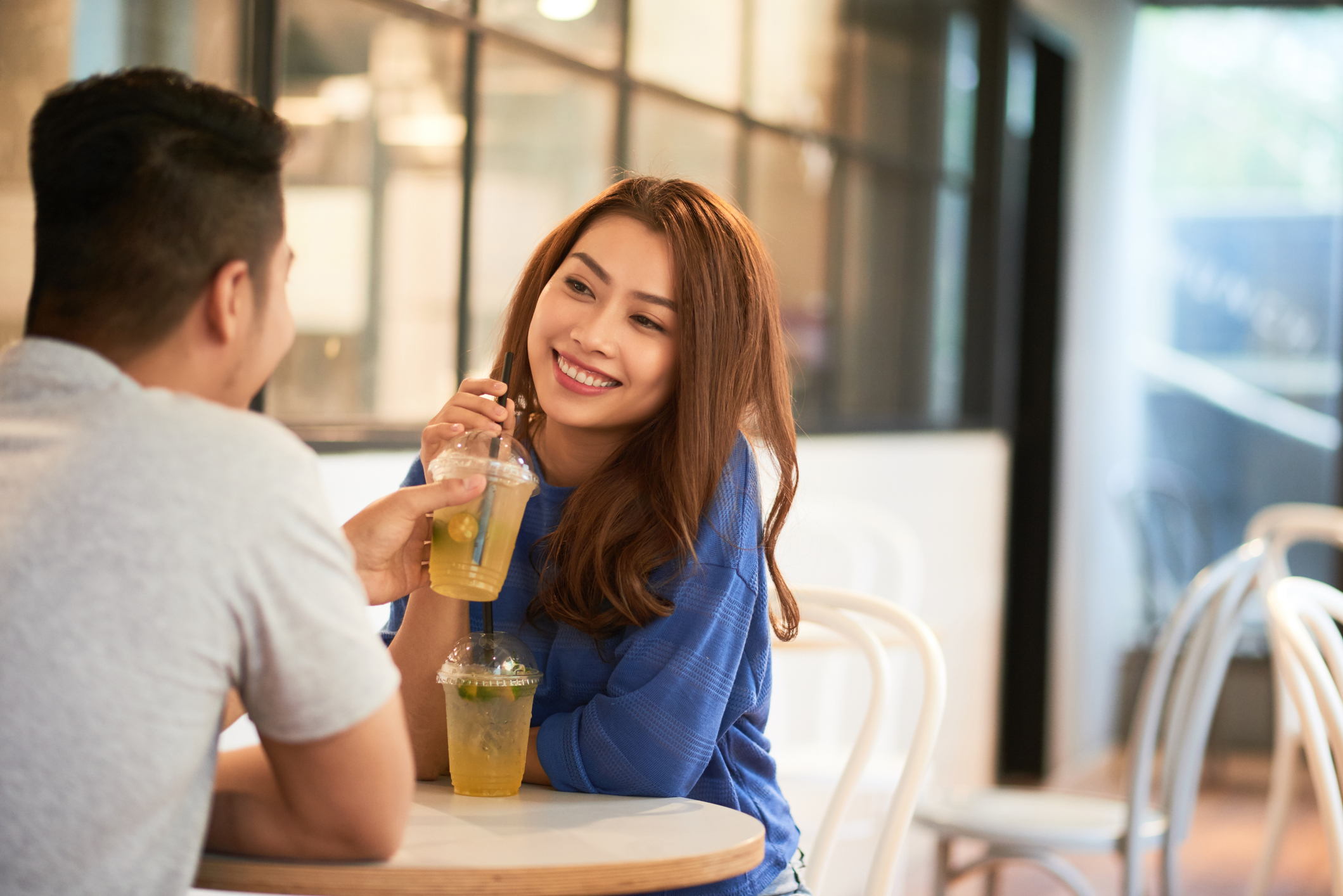 couple sitting at a table drinking iced tea together