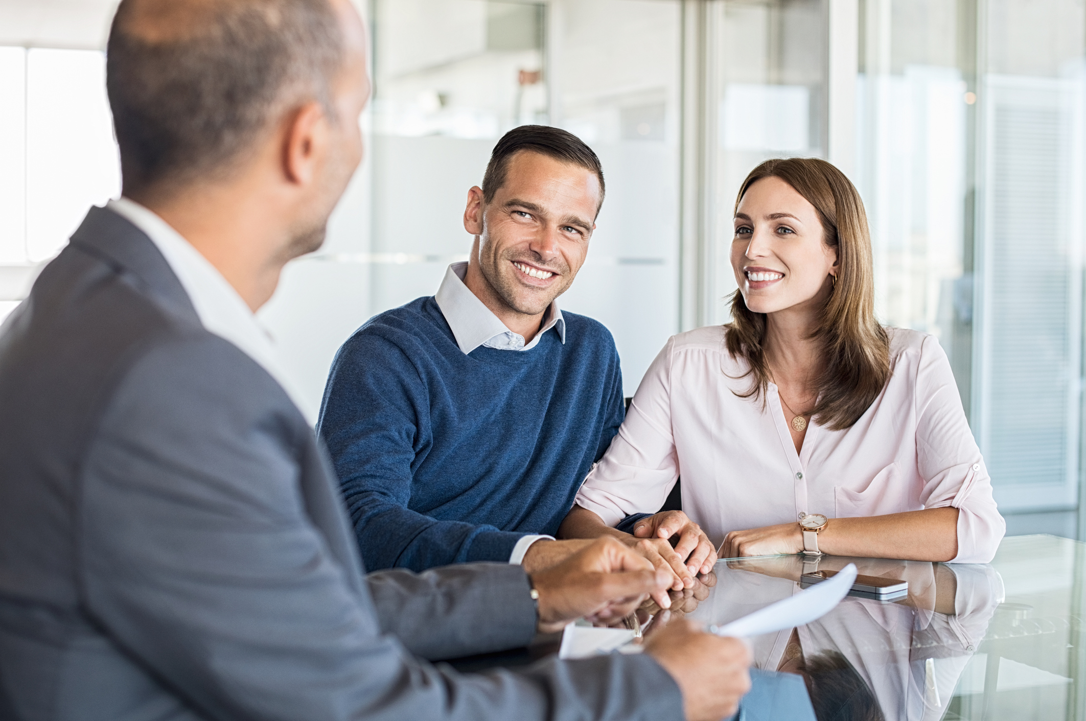 A banker holding a discussion with clients.