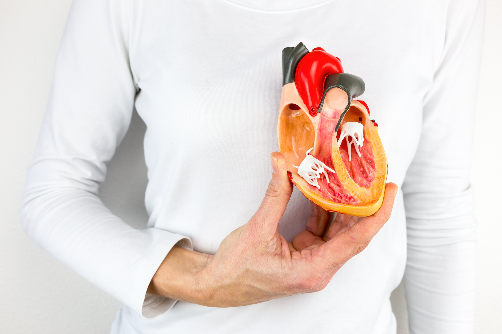 Man with half of a fake heart in front of his real heart