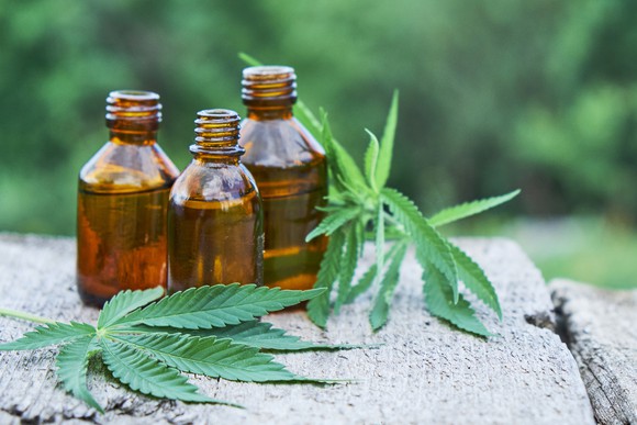 Marijuana leaves and bottles of derivative product