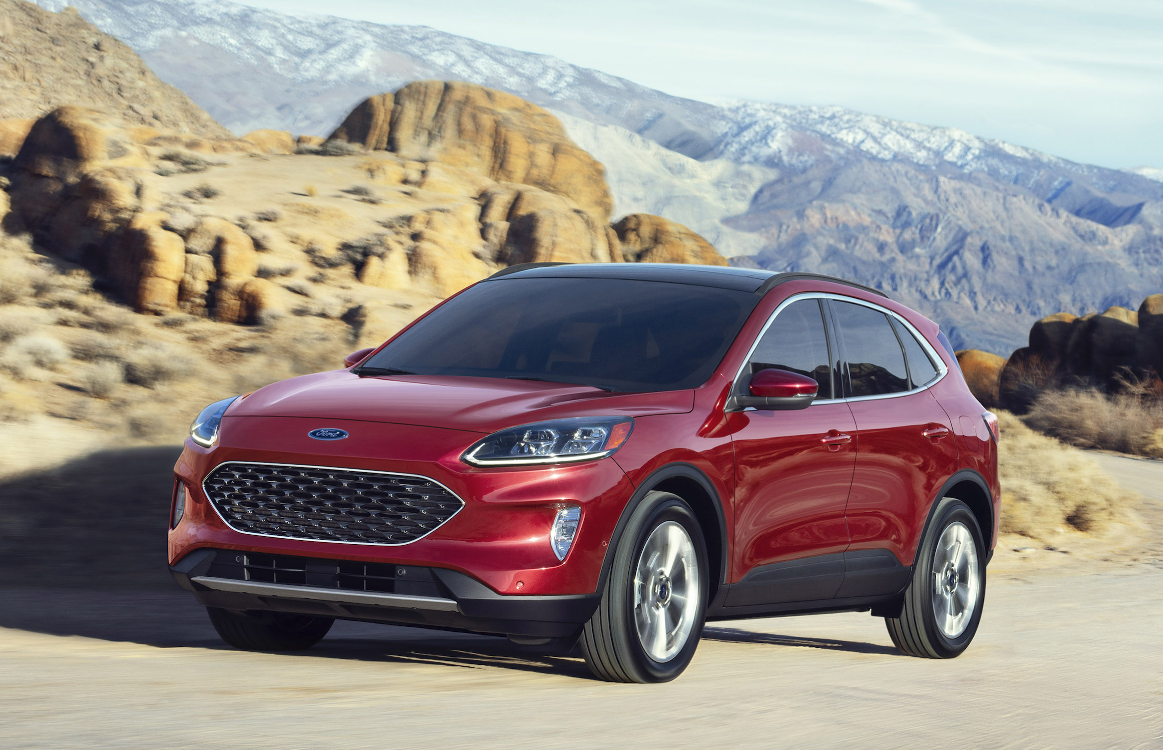 A red 2020 Ford Escape, a compact crossover SUV, on a mountain road.