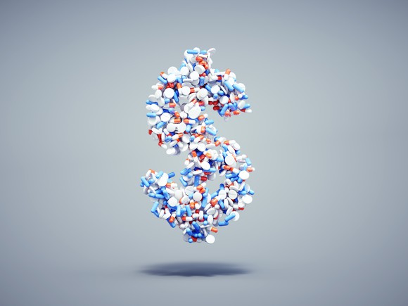 A dollar sign formed out of random pills and capsules.