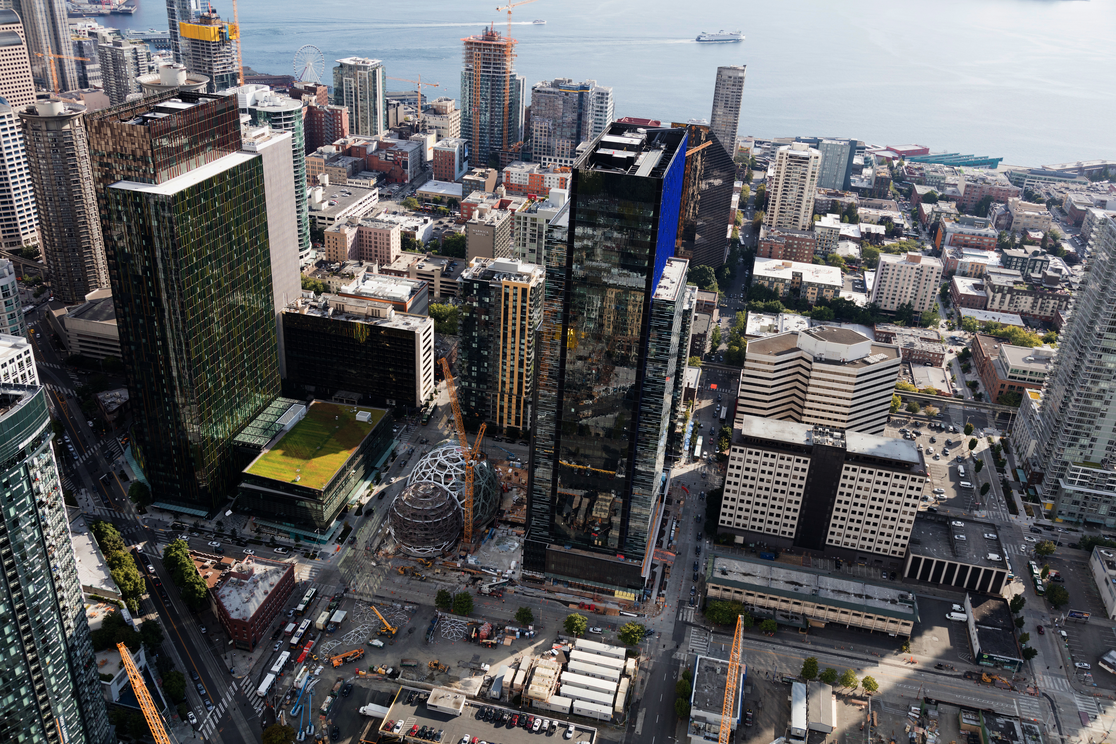 Several skyscrapers near a body of water in the background