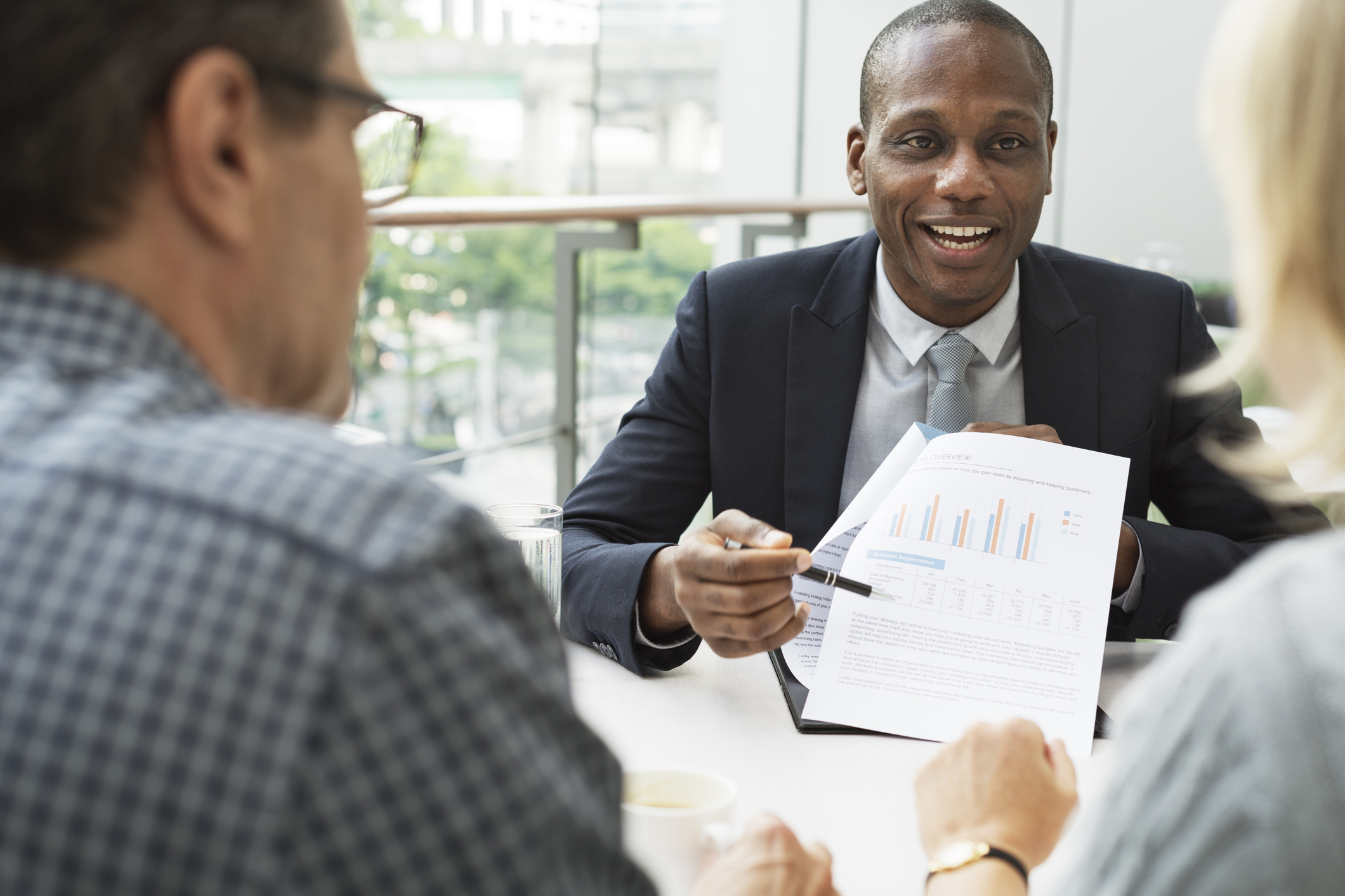 Man and woman talking to a financial advisor.