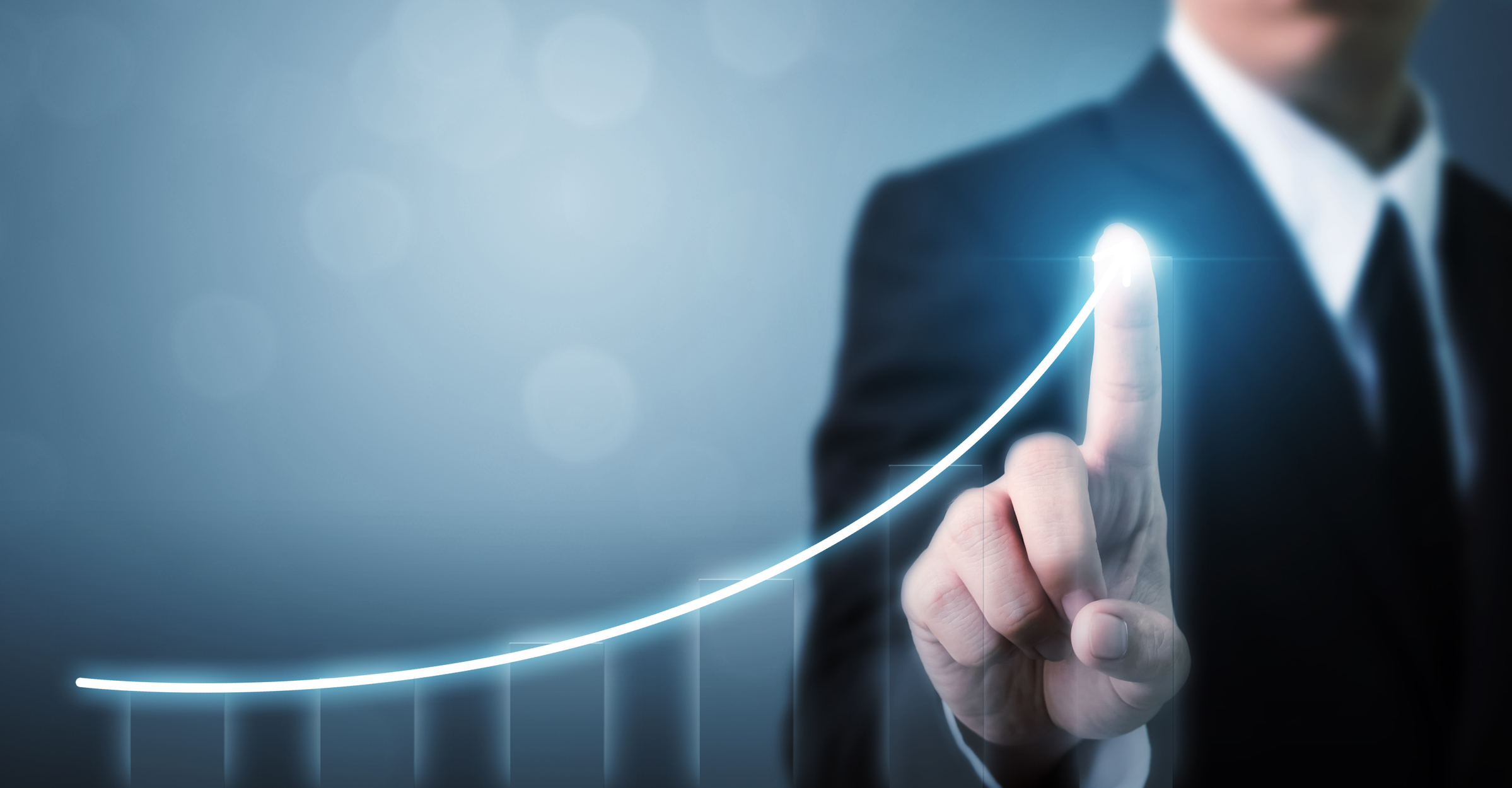 Businessman pointing to a shining point at the end of a line trending upward.