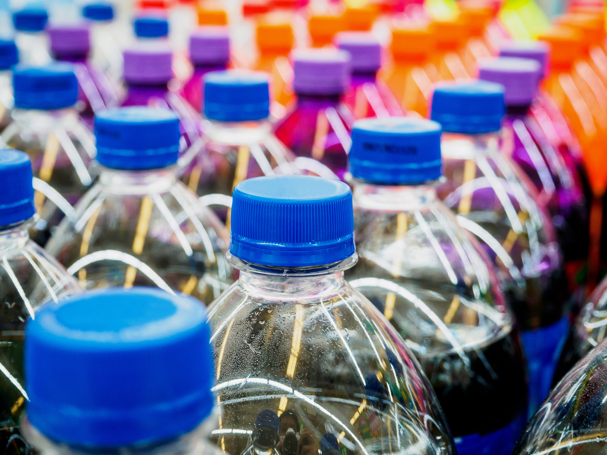 Colorful rows of soft drink bottles.