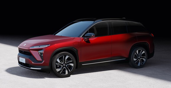 A red NIO ES6, a sleek electric crossover SUV.