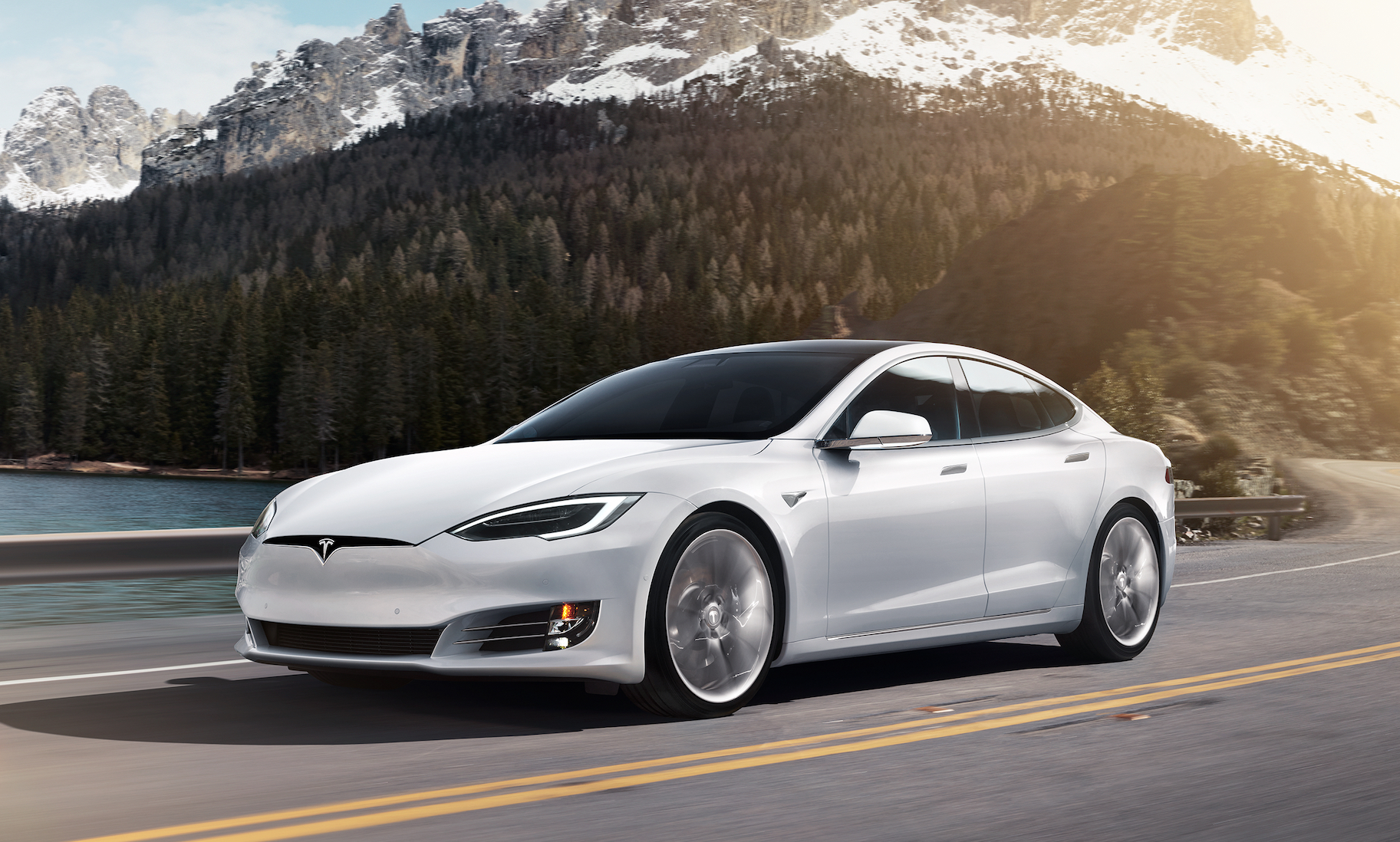 A white Tesla Model S, a large electric luxury-performance sedan.