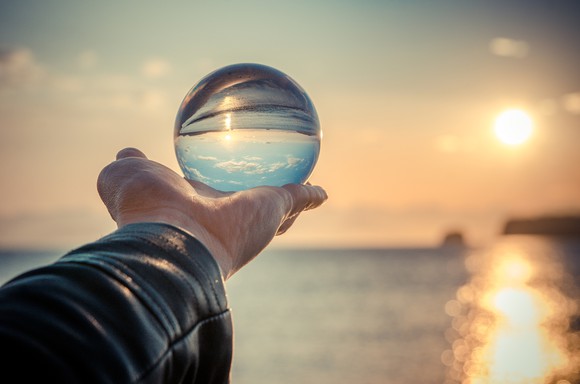 A man holding up a crystal ball.