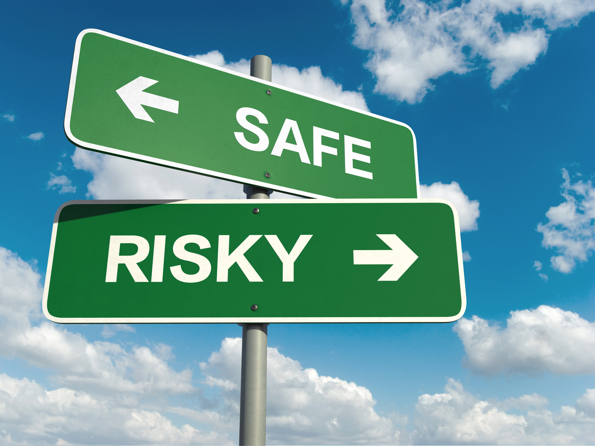 Green highway signs that say safe and risky with arrows pointing in opposite directions.