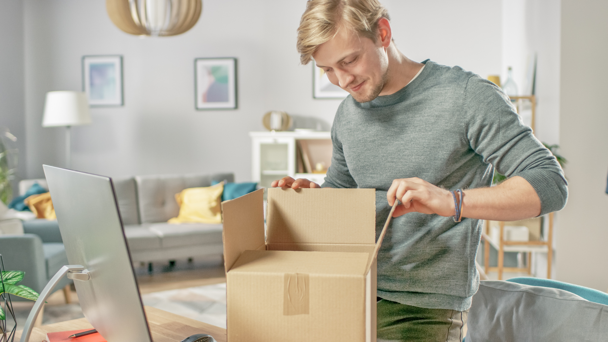 Man opening an online purchase box.