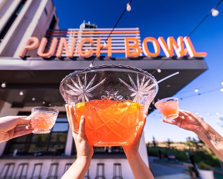 Glasses raised with punch bowl
