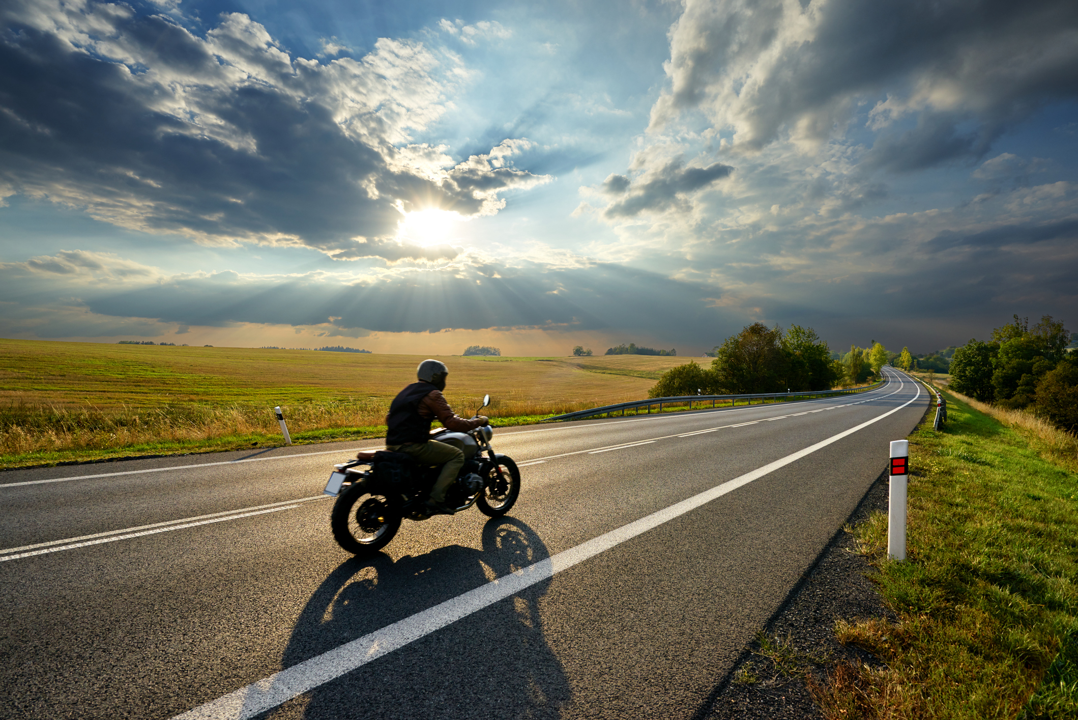 Motorcycle rider on open road.