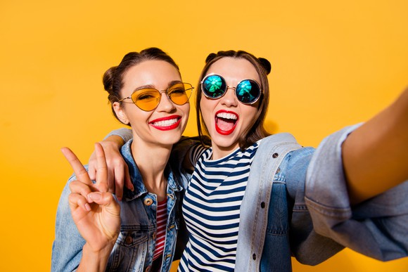 Two young women take a selfie.