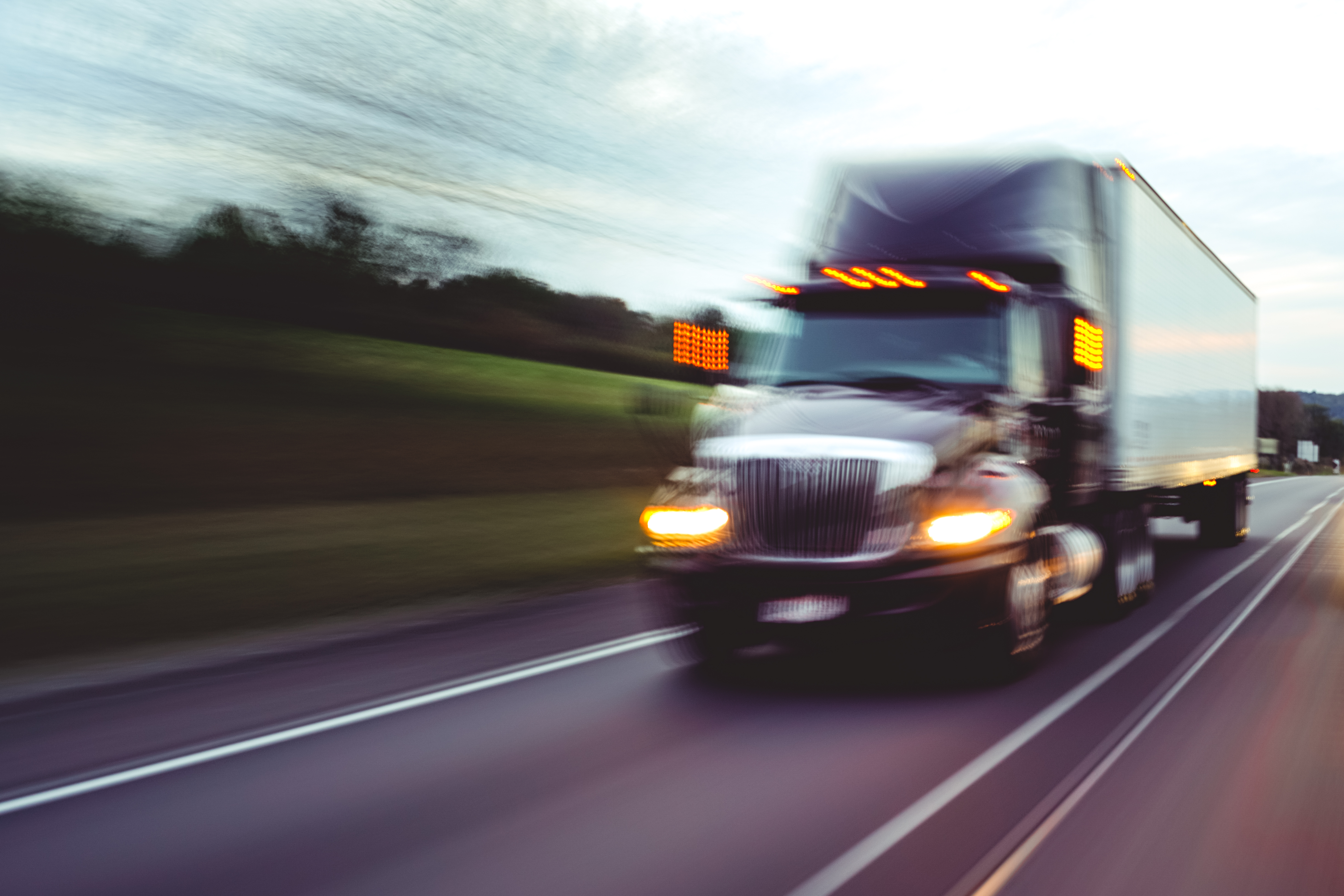 A freight truck driving down the highway