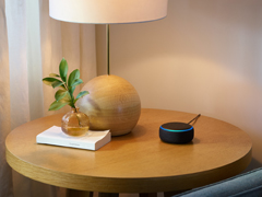 The Amazon Echo Dot is seen on a table.